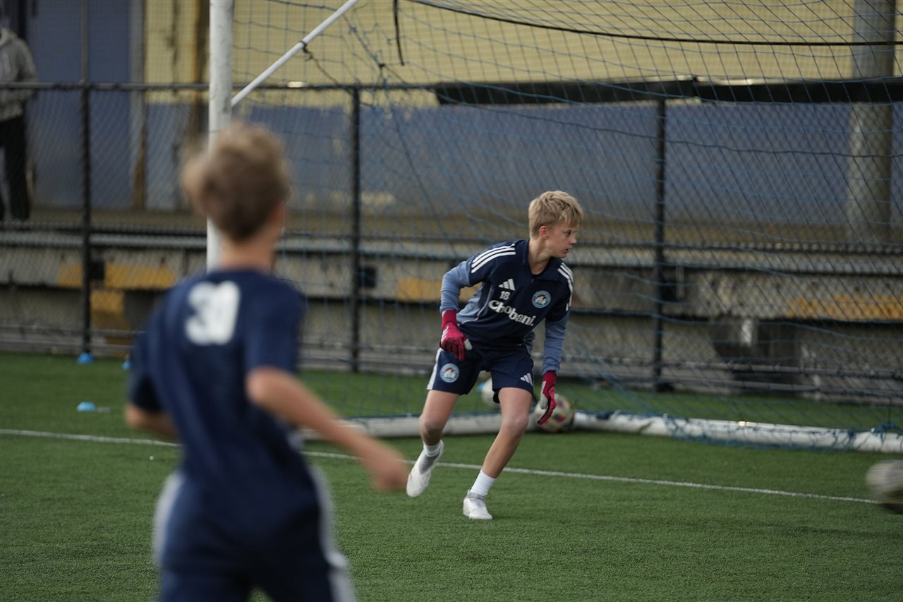 Young person wearing a Chobani t-shirt while playing soccer.