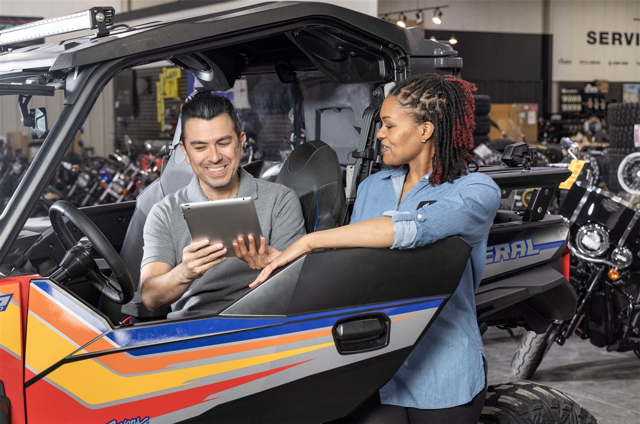 Man buys ATV at power sports store. Synchrony helps businesses with digital tools, training and financing infrastructure.