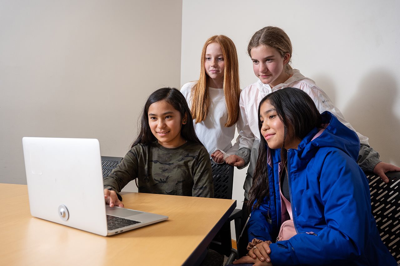 Four girls attending a class on a laptop at Standofrn Online High School.