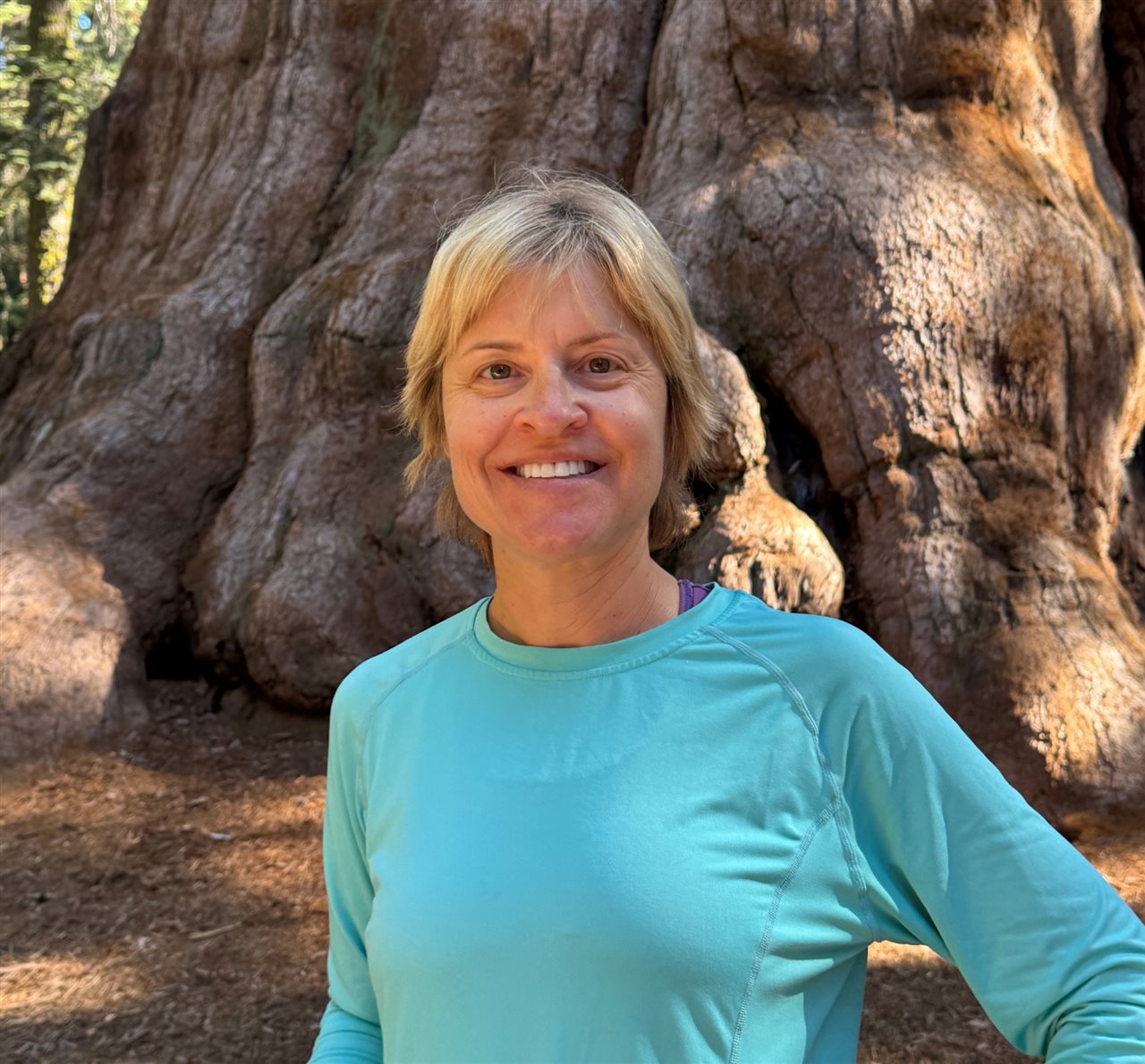 Sherri standing in front of a secquia tree