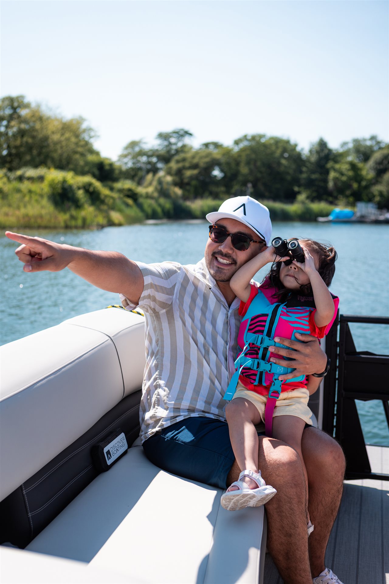 Dad and daughter on a boat. Discover Boating says 