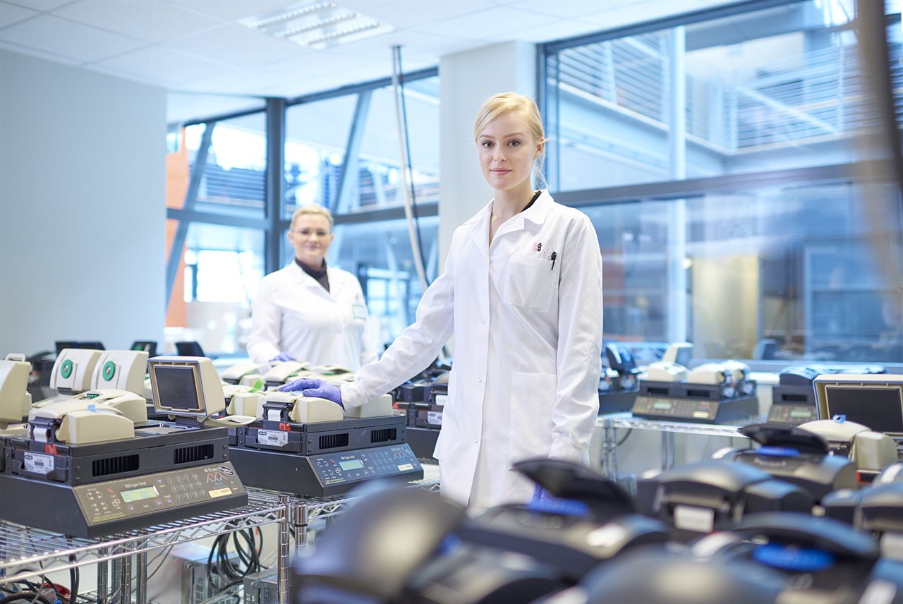 Two lab technicians at work. Amgen deCODE Genetics make DNA discoveries that reveal protective genes against obesity, bipolar disorder, and cancer.