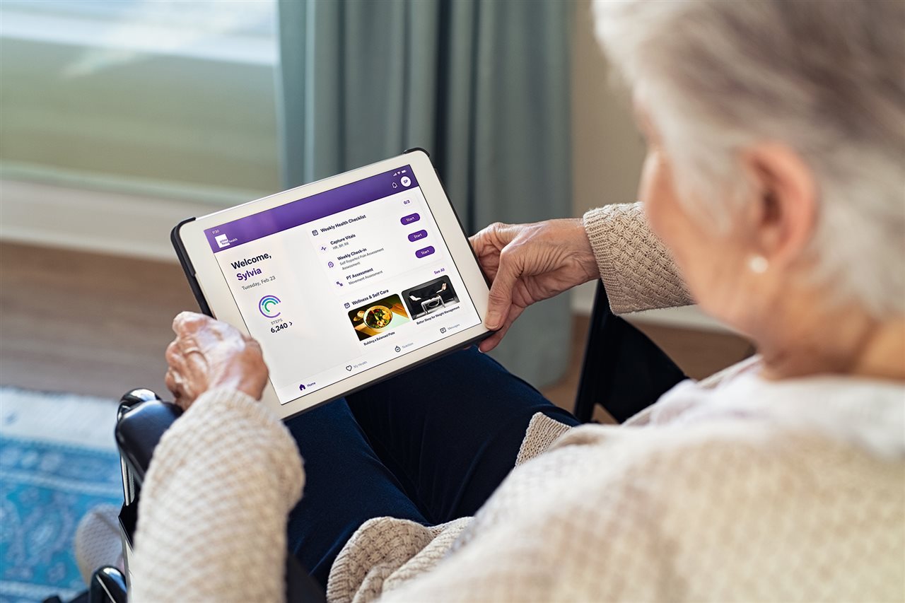 Senior woman using a tablet from home. Primefocus Health reimagines how healthcare happens beyond the clinic.