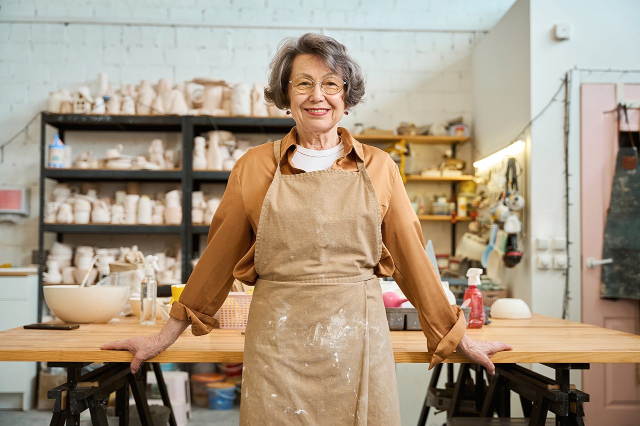 Smiling older woman in her craft room