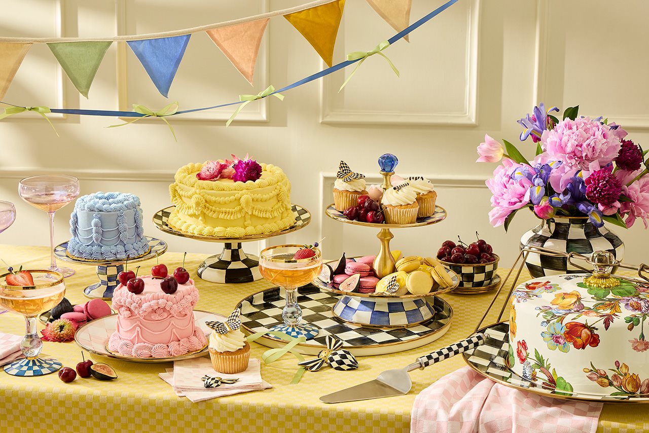 A table covered in opulent desserts on MacKenzie-Childs dish ware.
