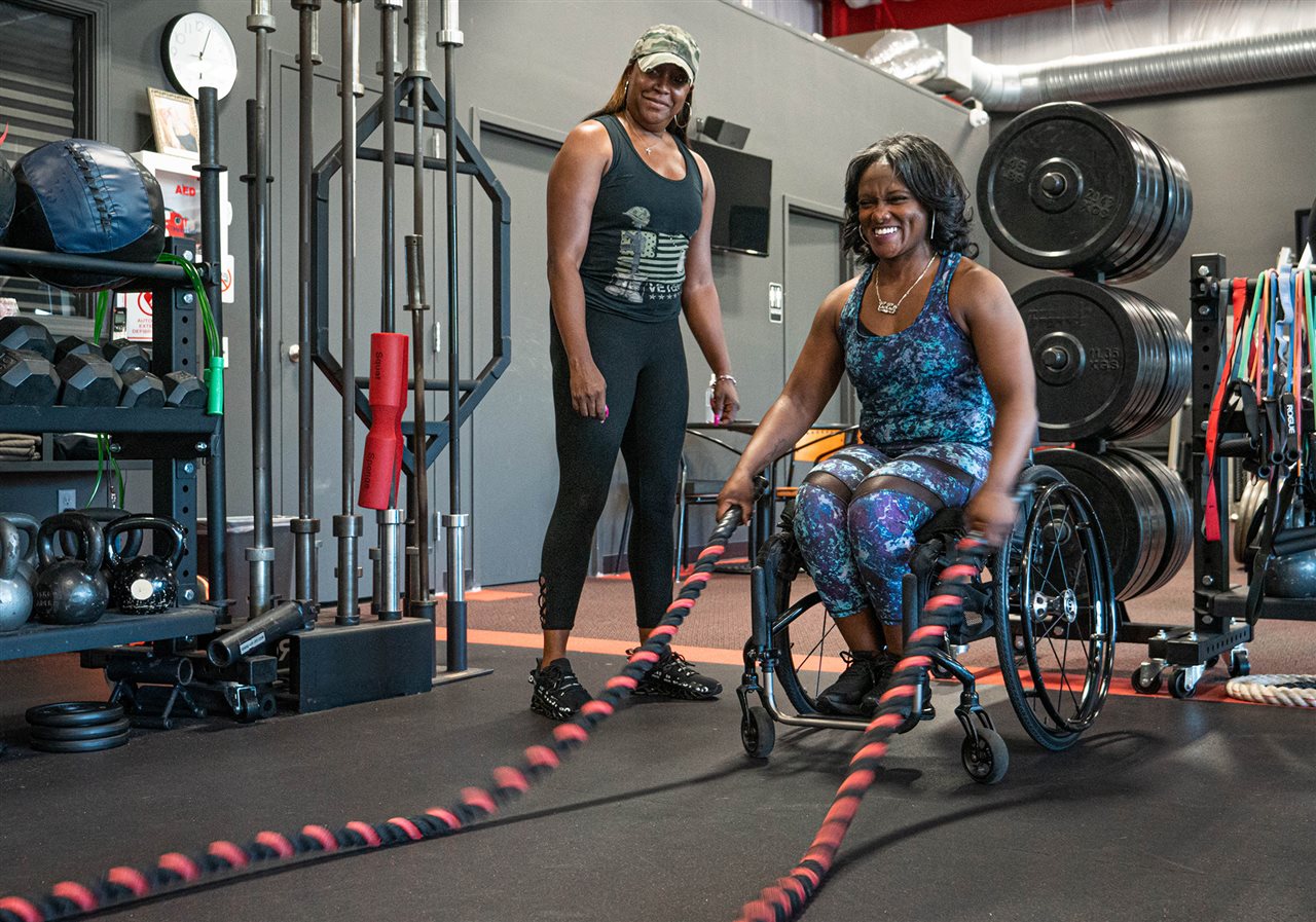 Ce-ce and Tiffany using battle ropes to build strength