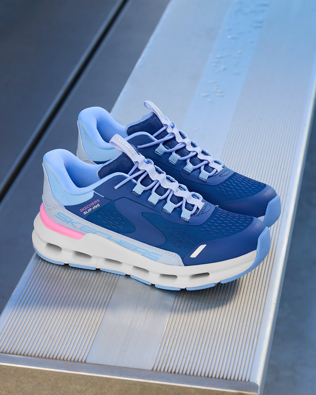 A pair of blue, pink and whilte Skechers Hands Free Slip-ins<sup><sup><sup><sup><sup><sup>&reg;</sup></sup></sup></sup></sup></sup> Glide-Step<sup><sup><sup><sup><sup><sup>&reg;</sup></sup></sup></sup></sup></sup> shoes.
