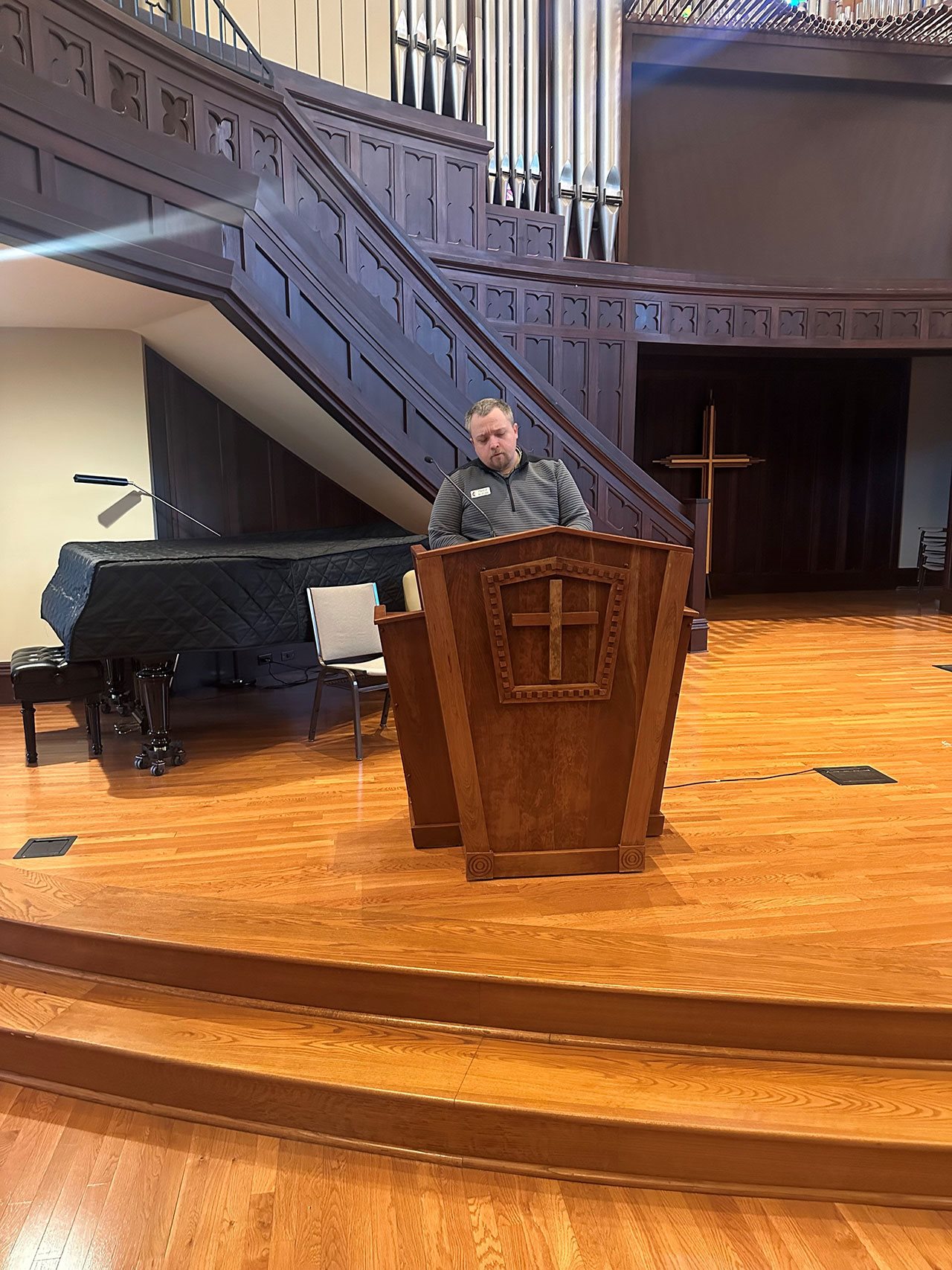 Pastor Austin behind a podium in churck