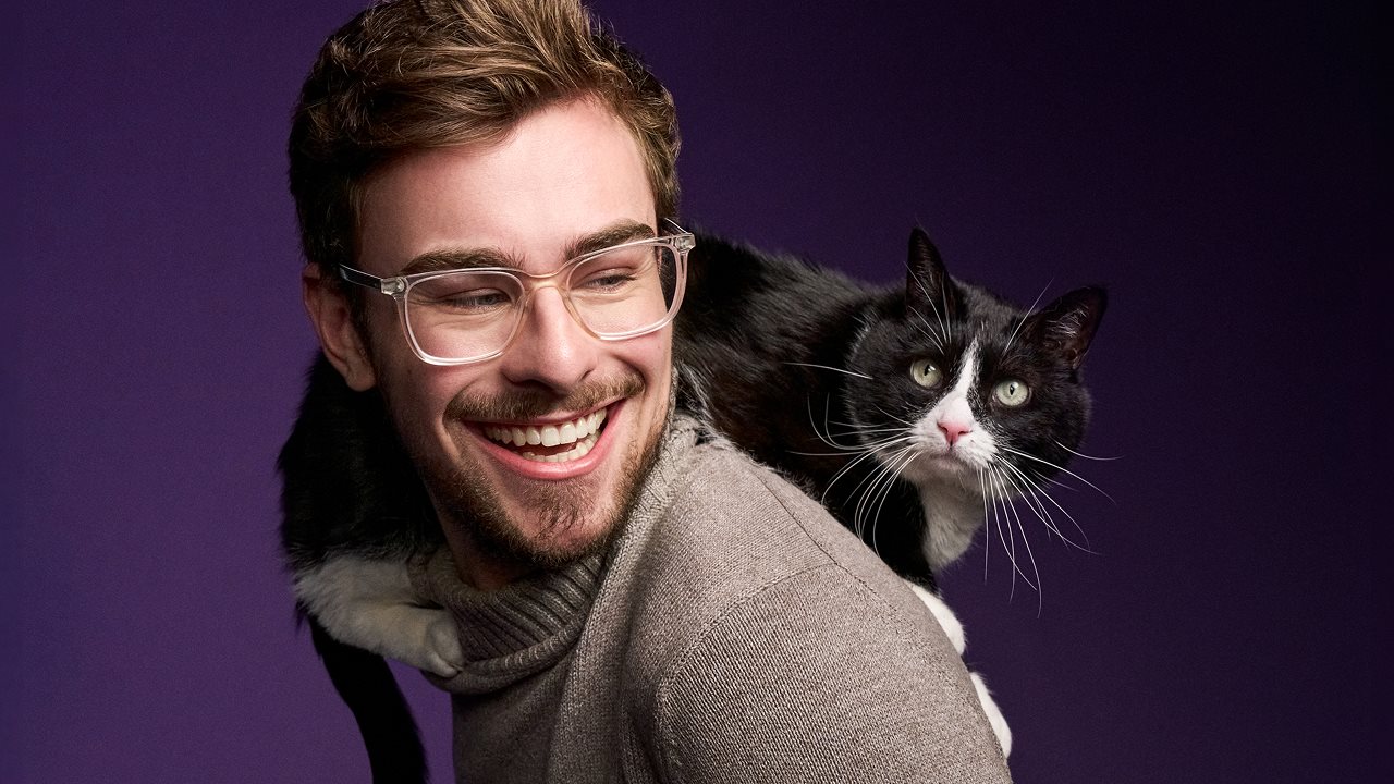 Cat dad carrying cat on his back.