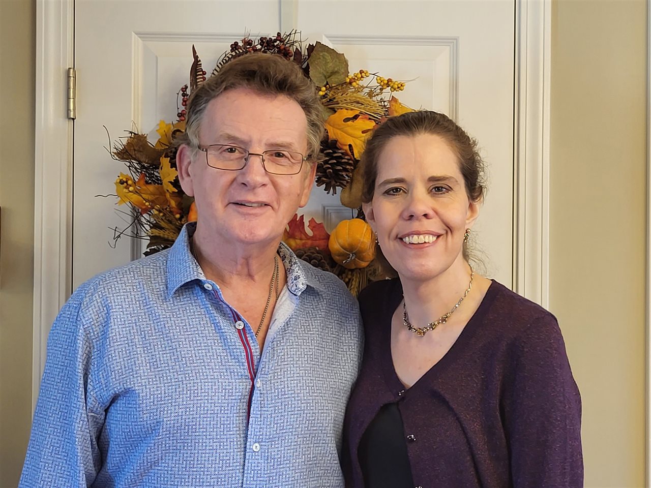 Dennis and significant other in the entryway of a home.