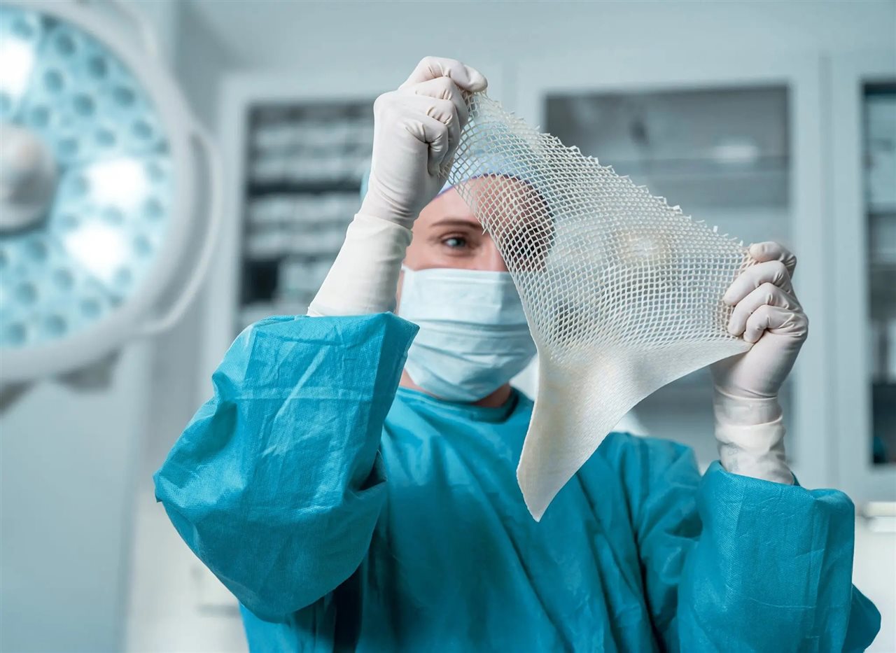 Woman in a lab looking through mesh. Kerecis is solving the global health crisis of chronic wounds with fish skin.