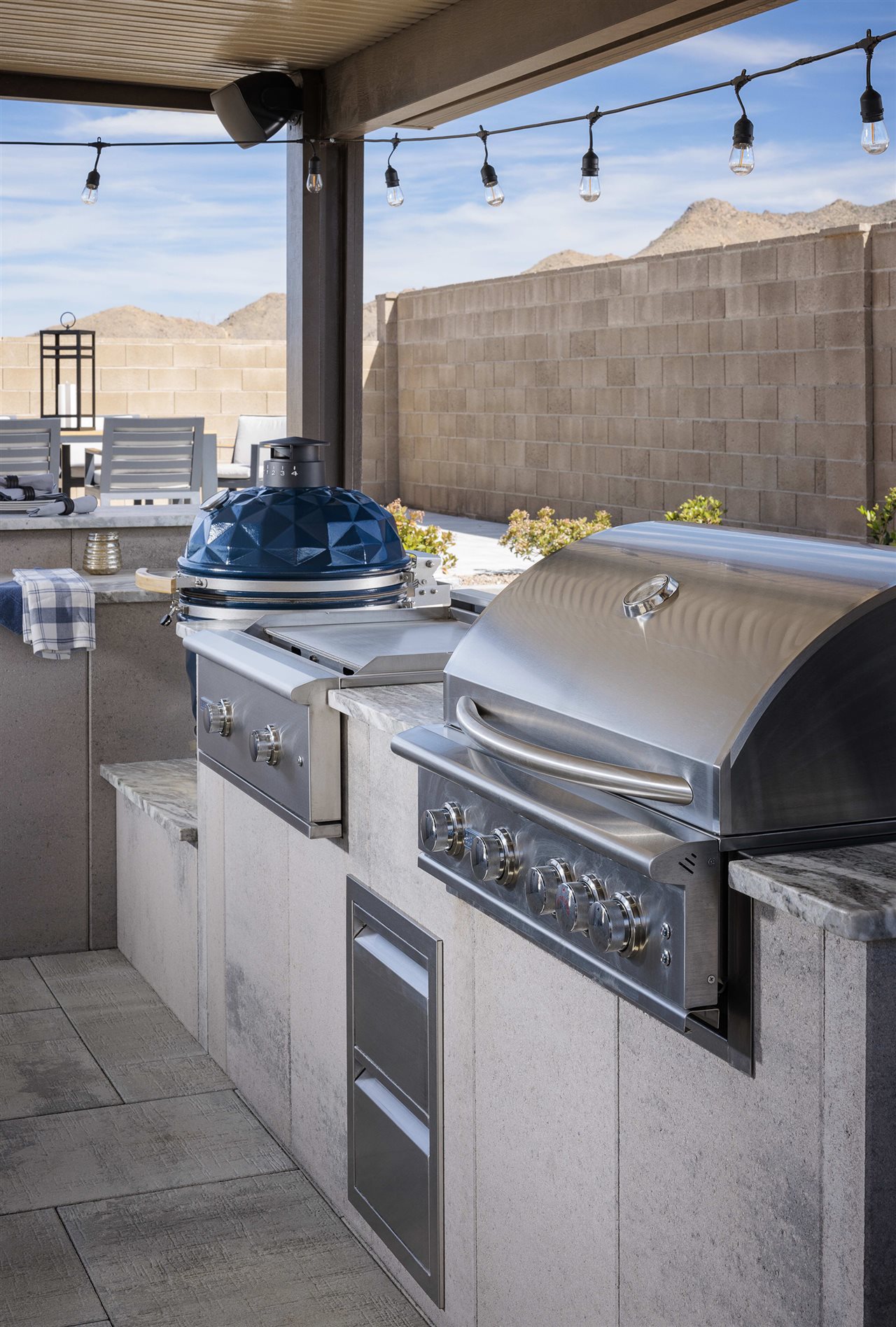 Belgard outdoor ktichen featuring a grill, smoker and stovetop.