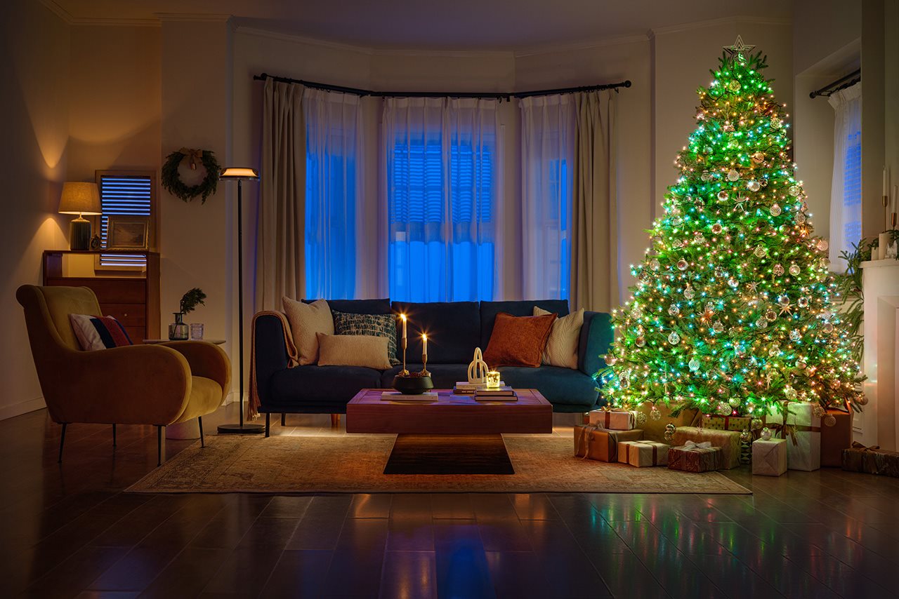 Christmas tree in a living room with green lights.